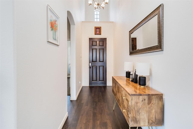 entryway featuring a chandelier and dark wood-type flooring