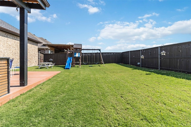 view of yard with a deck and a playground