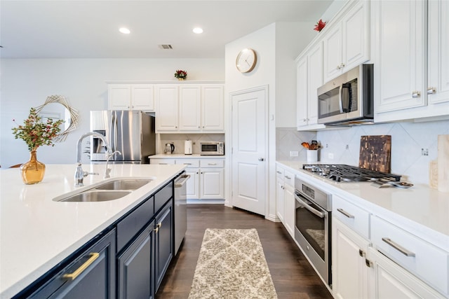 kitchen featuring sink, white cabinets, stainless steel appliances, and dark hardwood / wood-style floors