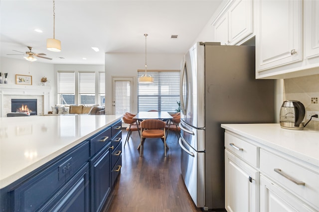 kitchen featuring pendant lighting, dark hardwood / wood-style flooring, and blue cabinetry