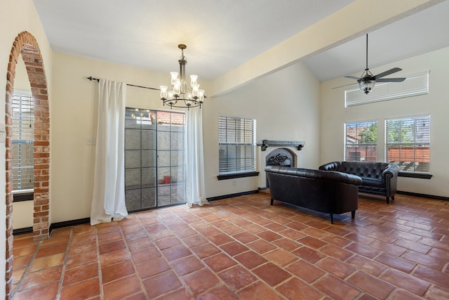 living room featuring vaulted ceiling and ceiling fan with notable chandelier