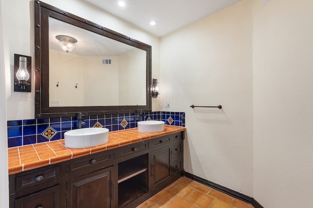 bathroom featuring vanity and backsplash