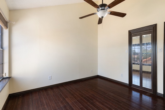 empty room with lofted ceiling, a textured ceiling, ceiling fan, and dark hardwood / wood-style flooring