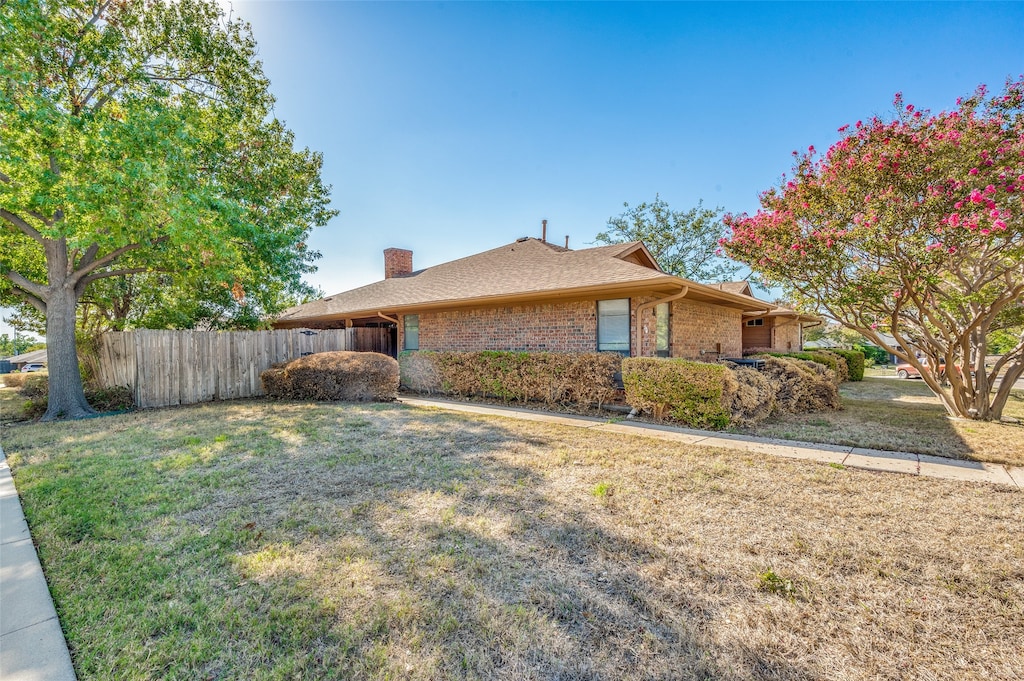 view of side of property with a lawn