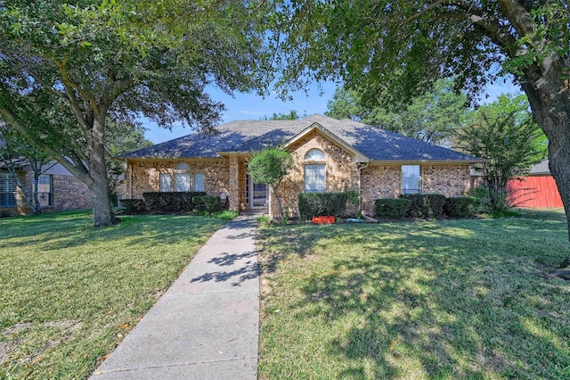 single story home with brick siding, a front yard, and fence