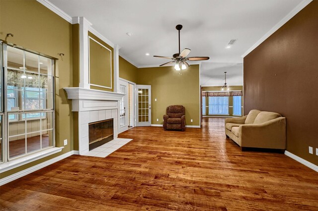 wine room featuring ceiling fan with notable chandelier, crown molding, and hardwood / wood-style floors