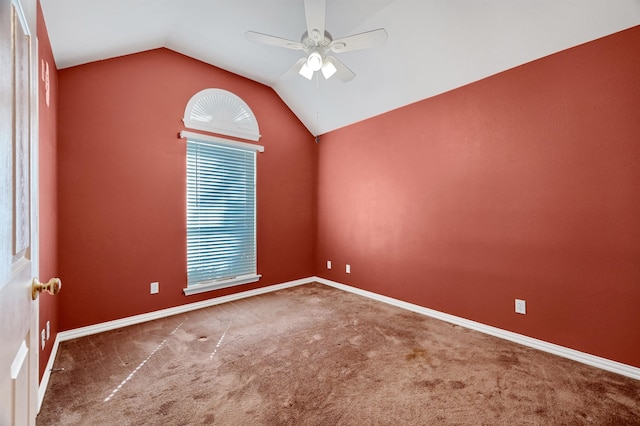 unfurnished room with lofted ceiling, dark carpet, and ceiling fan