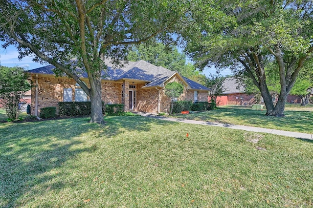 single story home with a front yard and brick siding