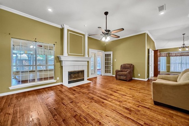 unfurnished living room featuring plenty of natural light, crown molding, and hardwood / wood-style flooring