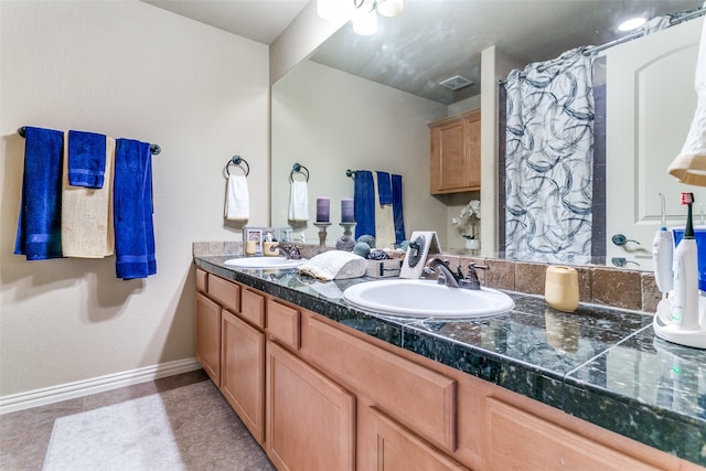 bathroom featuring tile patterned floors, ceiling fan, and vanity