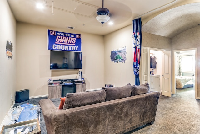 carpeted living room featuring vaulted ceiling and ceiling fan