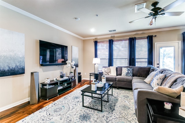 living room featuring wood-type flooring, crown molding, and ceiling fan