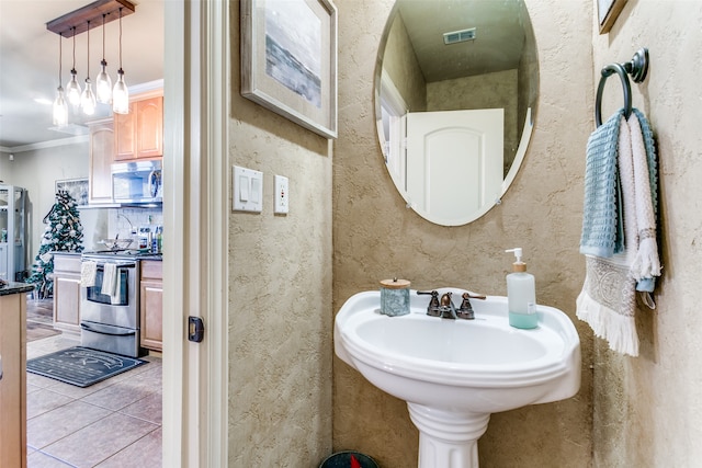 bathroom with crown molding and tile patterned floors