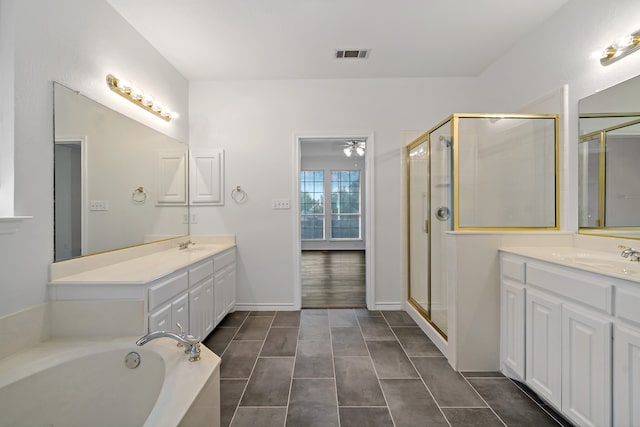 bathroom featuring tile patterned flooring, shower with separate bathtub, and vanity