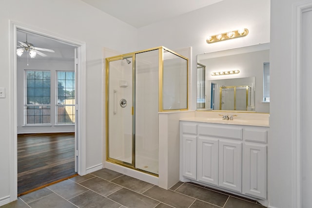 bathroom featuring vanity, hardwood / wood-style flooring, walk in shower, and ceiling fan