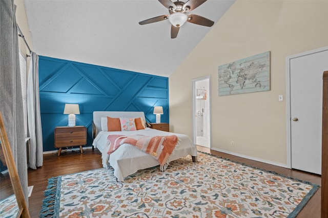 bedroom with ceiling fan, hardwood / wood-style flooring, lofted ceiling, and ensuite bath