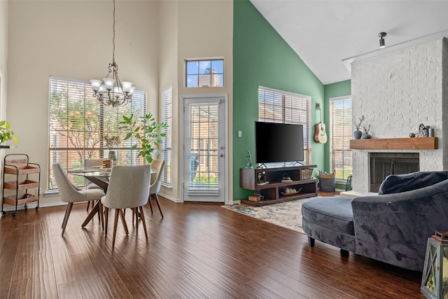 living room with high vaulted ceiling, a wealth of natural light, a fireplace, and dark hardwood / wood-style floors