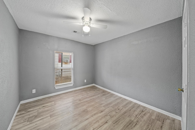 unfurnished room with light hardwood / wood-style flooring, a textured ceiling, and ceiling fan