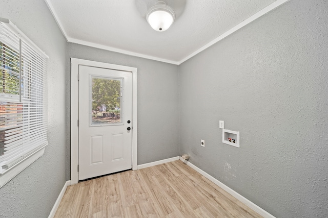 clothes washing area with light hardwood / wood-style floors, hookup for a washing machine, ornamental molding, and plenty of natural light