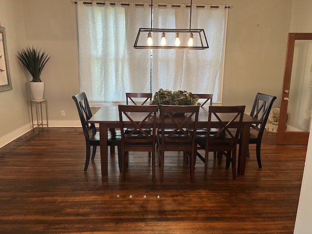 dining space with dark wood-type flooring