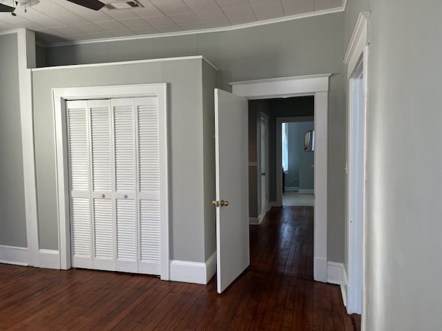 hall with crown molding and dark hardwood / wood-style floors