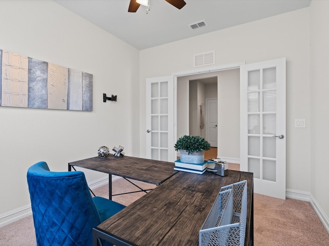 carpeted office space featuring french doors and ceiling fan