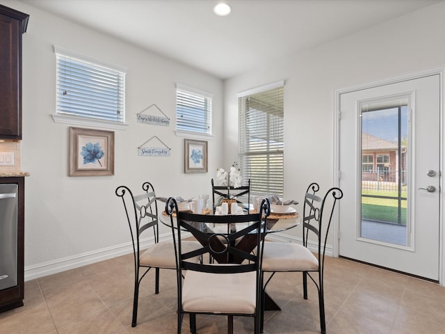 dining area with light tile patterned floors and a wealth of natural light