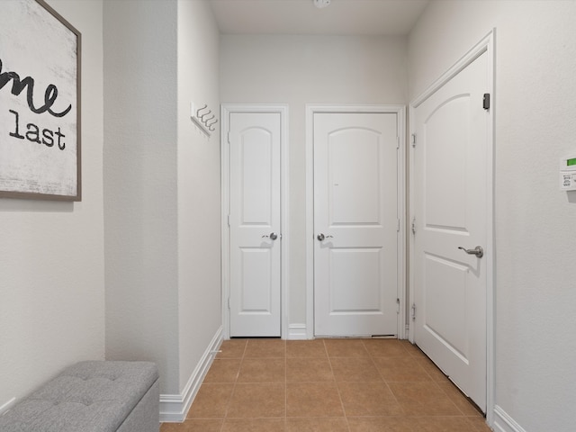 hallway with light tile patterned flooring