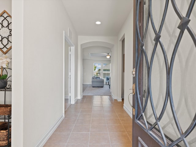 hall with light tile patterned floors