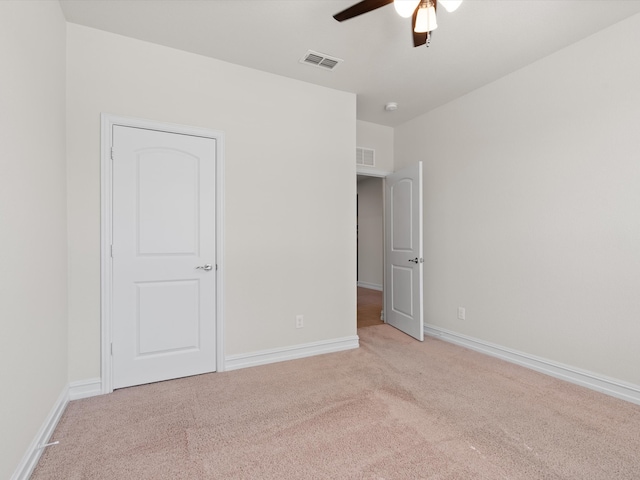 unfurnished bedroom with ceiling fan and light carpet