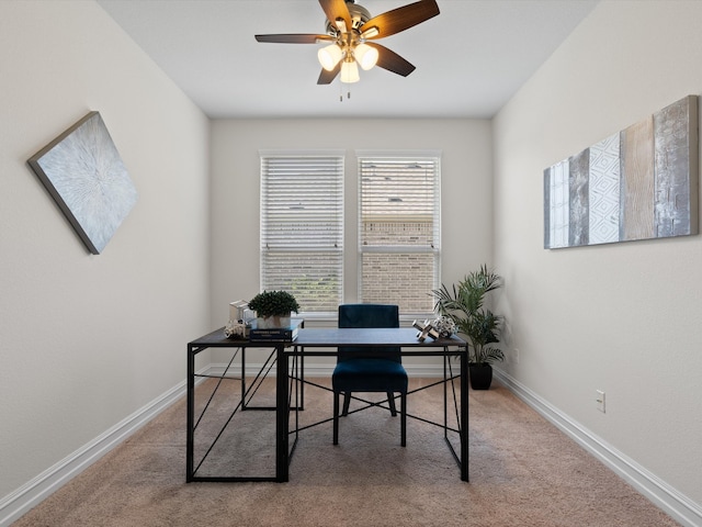 carpeted office space featuring ceiling fan