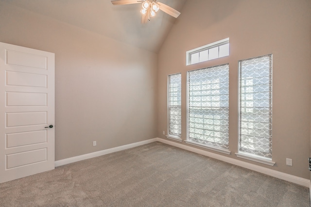 spare room featuring light carpet, high vaulted ceiling, and ceiling fan