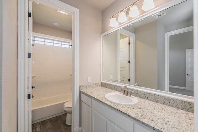 full bathroom with  shower combination, vanity, toilet, and hardwood / wood-style flooring