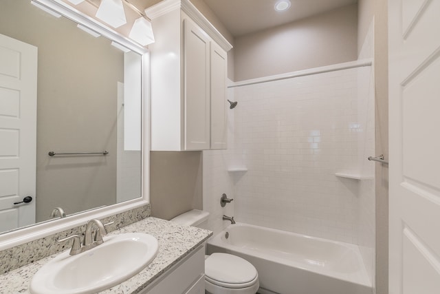 full bathroom featuring tiled shower / bath combo, vanity, and toilet