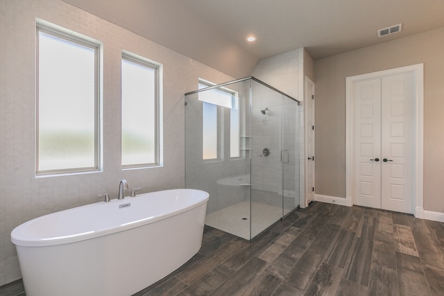 bathroom featuring independent shower and bath and wood-type flooring