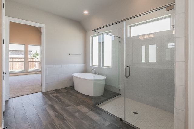 bathroom featuring lofted ceiling, plenty of natural light, separate shower and tub, and wood-type flooring