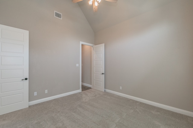 unfurnished room with light carpet, high vaulted ceiling, and ceiling fan