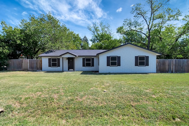 ranch-style home featuring a front yard