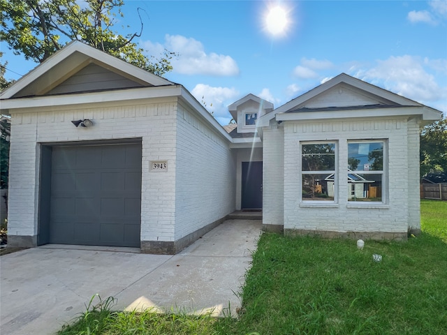 ranch-style home with a garage and a front lawn