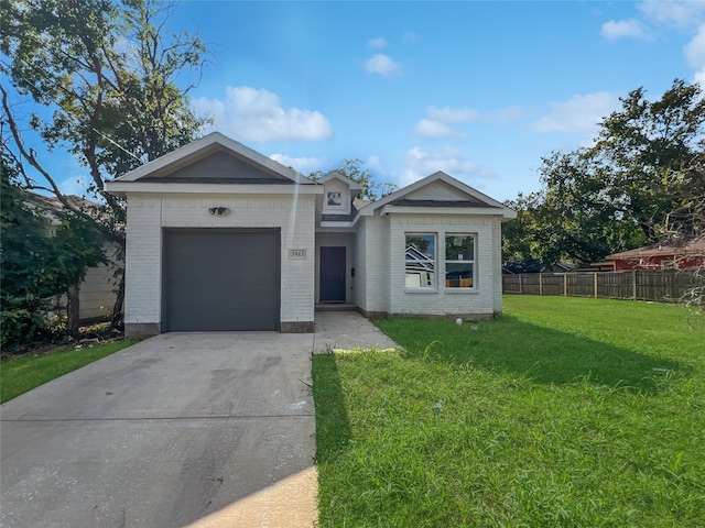 ranch-style house featuring a front yard and a garage