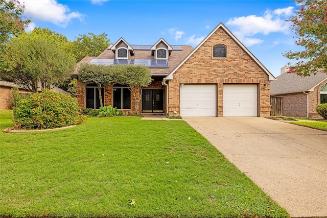 front facade with a front yard and a garage