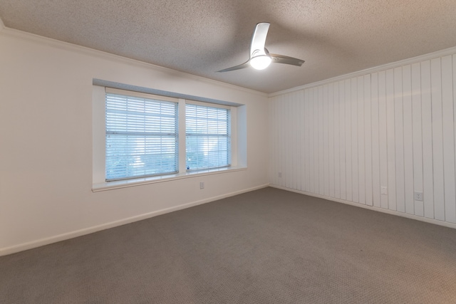 spare room featuring ceiling fan, carpet flooring, a textured ceiling, and ornamental molding