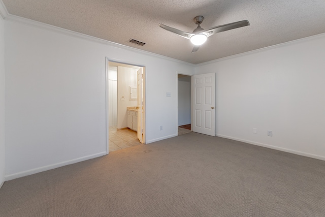 unfurnished bedroom featuring crown molding, light colored carpet, connected bathroom, and ceiling fan