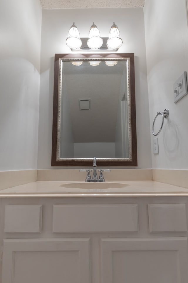 bathroom with vanity and a textured ceiling