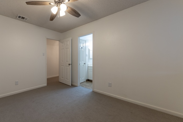 unfurnished room with carpet floors, a textured ceiling, and ceiling fan