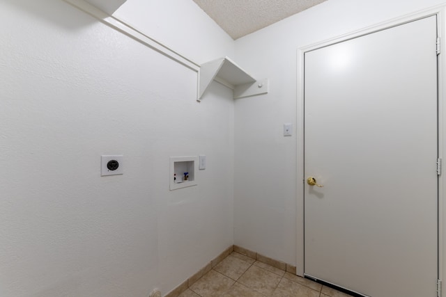 washroom featuring light tile patterned flooring, washer hookup, hookup for an electric dryer, and a textured ceiling