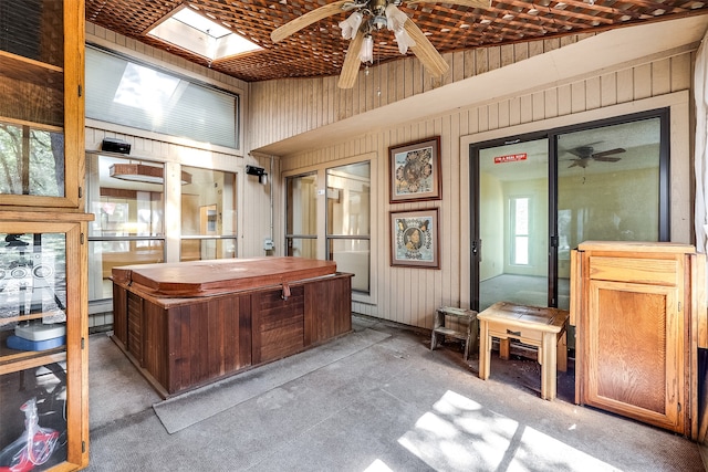 interior space with a skylight and ceiling fan