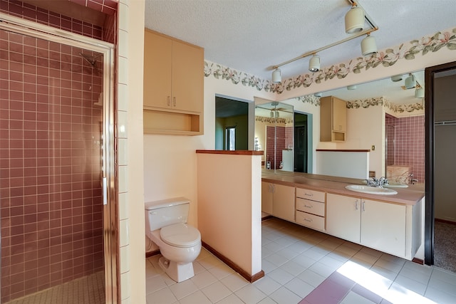 bathroom with walk in shower, tile patterned floors, vanity, and toilet