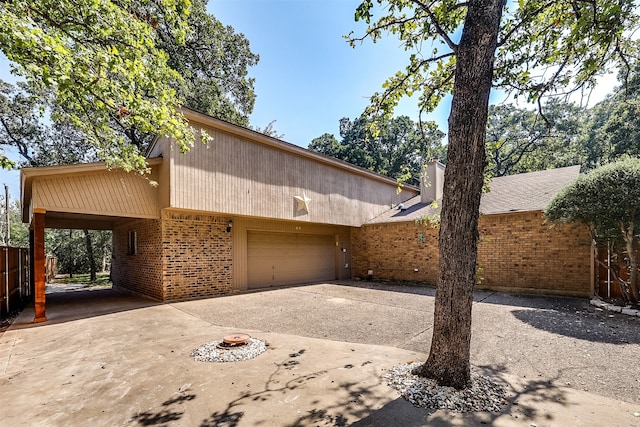 view of front of home featuring a garage and a carport