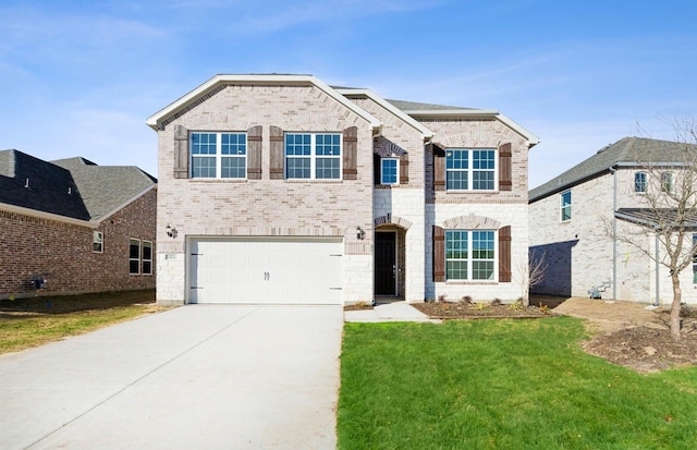 view of front of property featuring a garage and a lawn